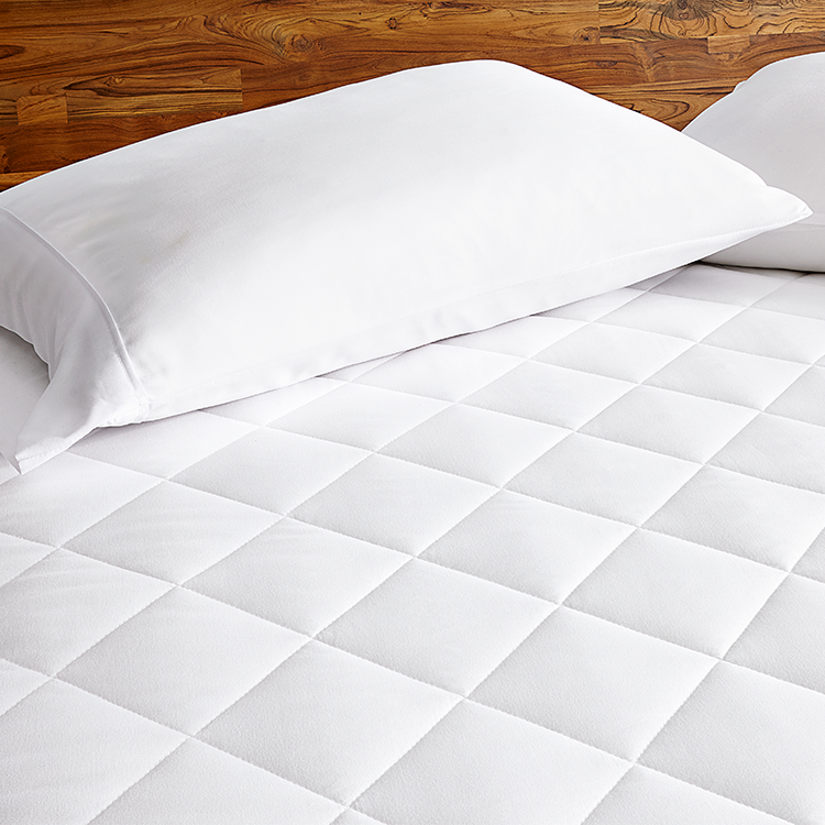 White Quilted Mattress Pad with a pillow