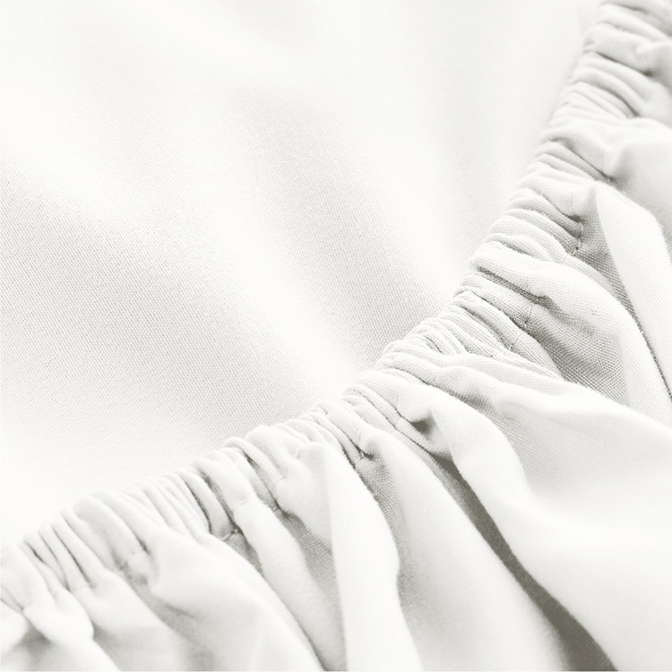 Closeup of white Ultra Soft Fitted Sheet with Pillowcase Set fabric, gathered elastic corner