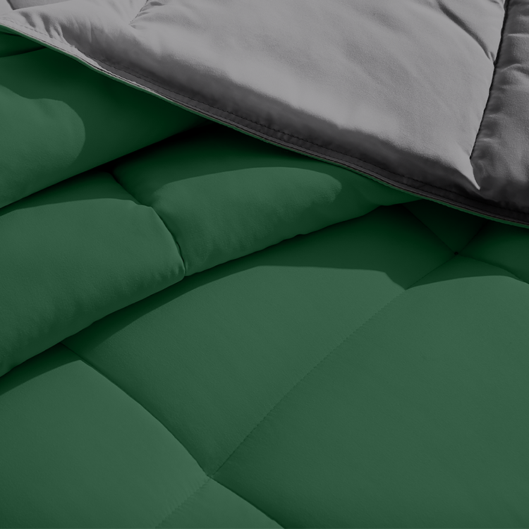 Closeup of dark green reversible Ultra Soft Reversible Bed In A Bag fabric edge