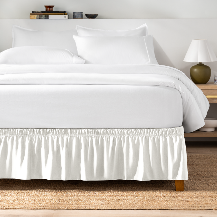 Bed with a white wrap-around bed skirt