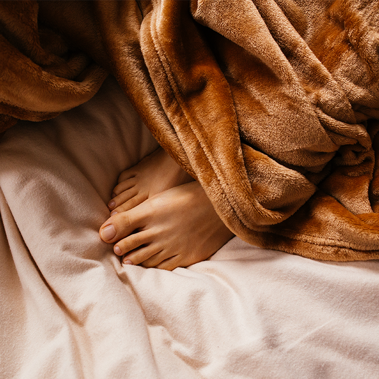 Close-up of a woman resting her head on a tan pillow, digital gift card photo