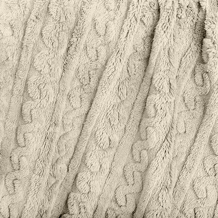 Close-up of tan cable knit faux shearling blanket texture