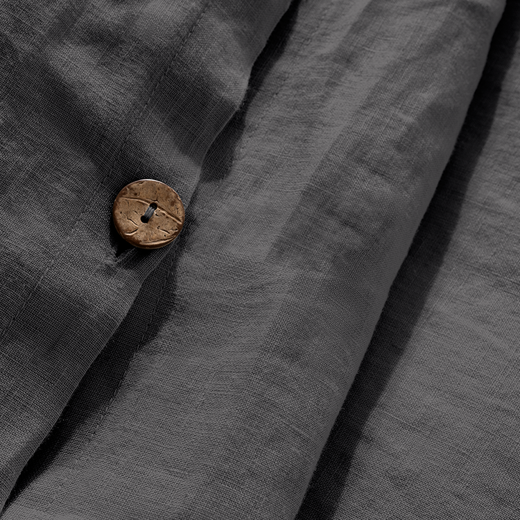 Closeup of dark charcoal European Linen Duvet Cover Set fabric with button closure