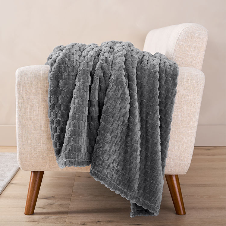 Gray Microplush Waffle Blanket draped over a chair