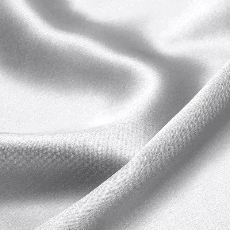 Close-up of white mulberry silk pillowcase set fabric