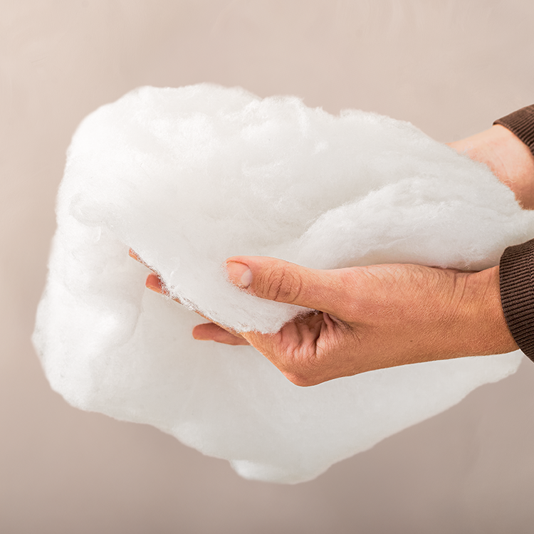 Hand pressing into a white Pillow Insert pillow, closeup