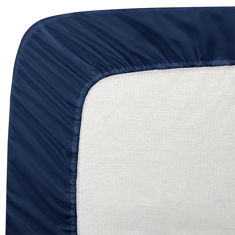Closeup of navy blue Quilted Mattress Pad fitted onto a mattress corner