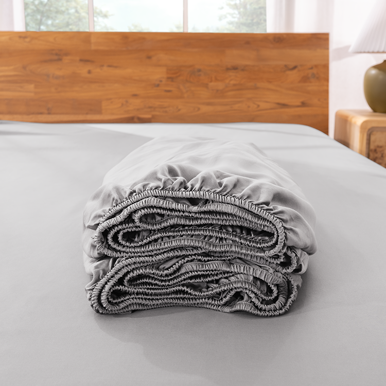 Close-up of folded gray bamboo fitted sheet fabric