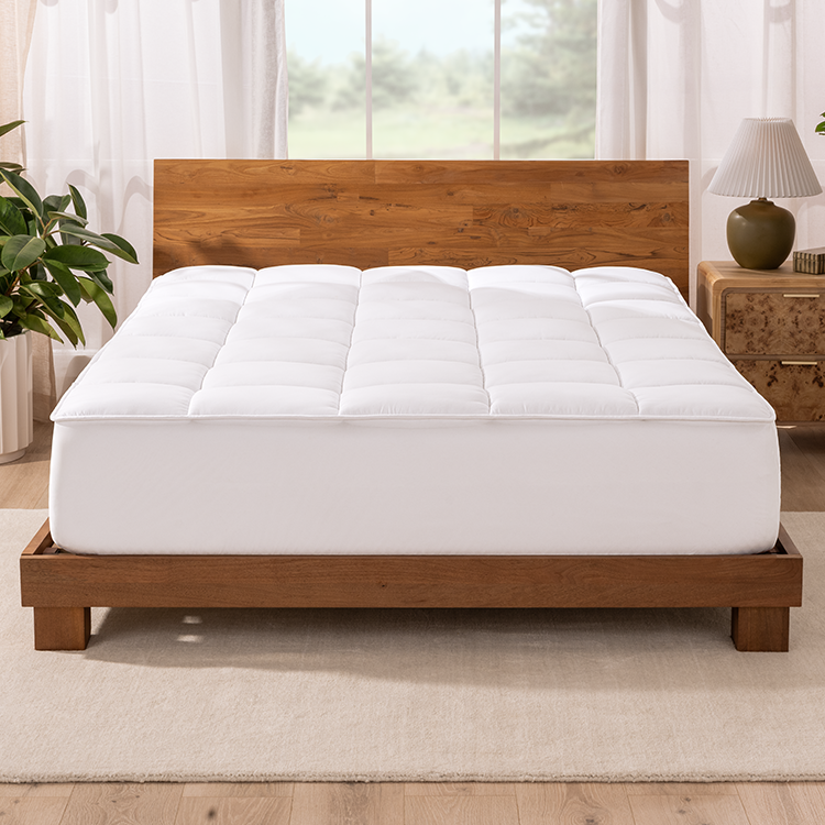 Bed styled with white Reversible Mattress Pad and wood bed frame