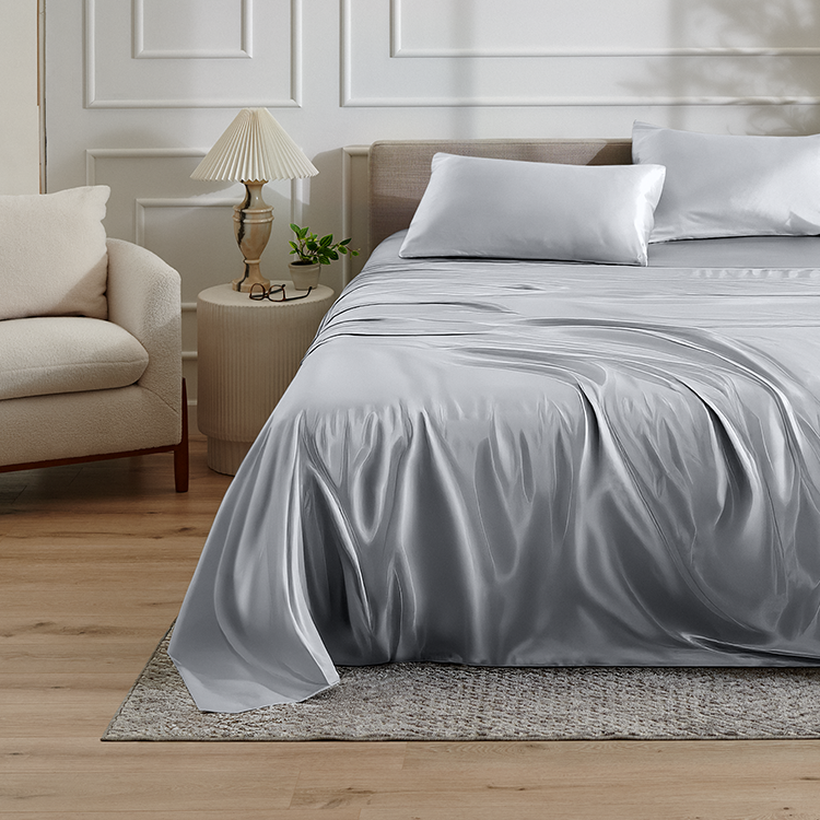 Bed with a gray satin sheet set