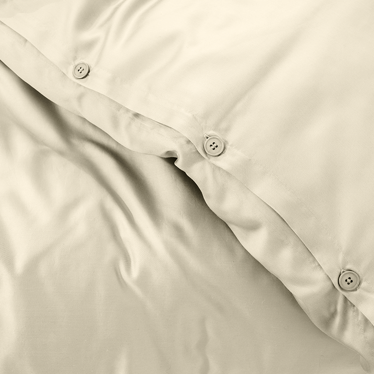 Closeup of cream TENCEL Lyocell Duvet Cover Set fabric, draped folds
