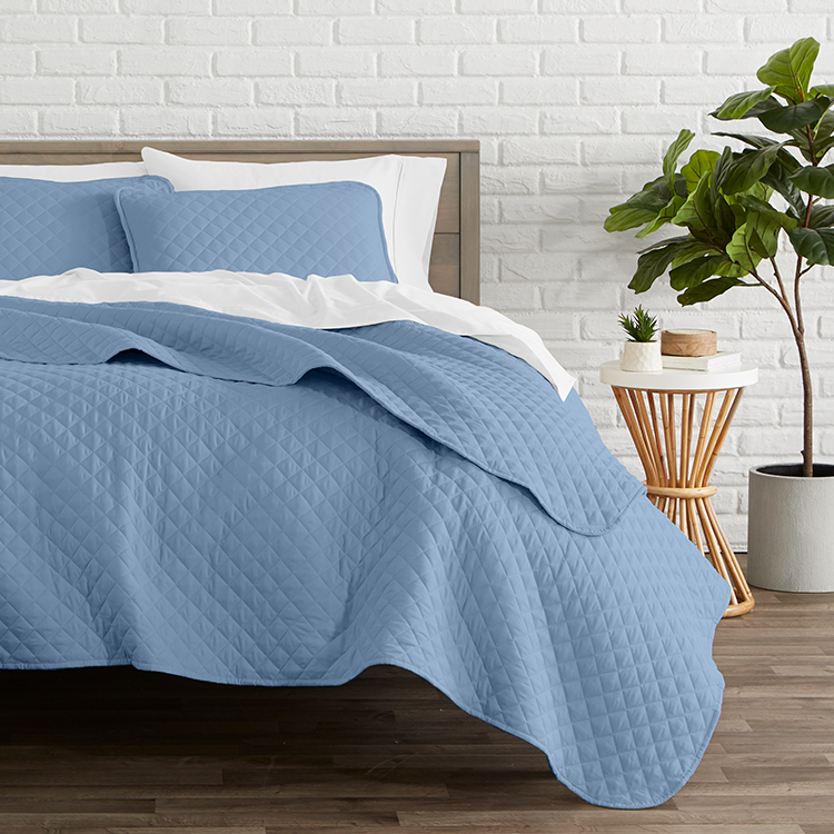 Bed with blue quilted Ultra Soft Quilt Set