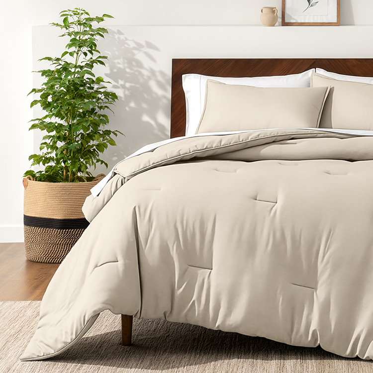 Bed styled with taupe Ultra Soft Track Stitch Comforter Set, plant nearby