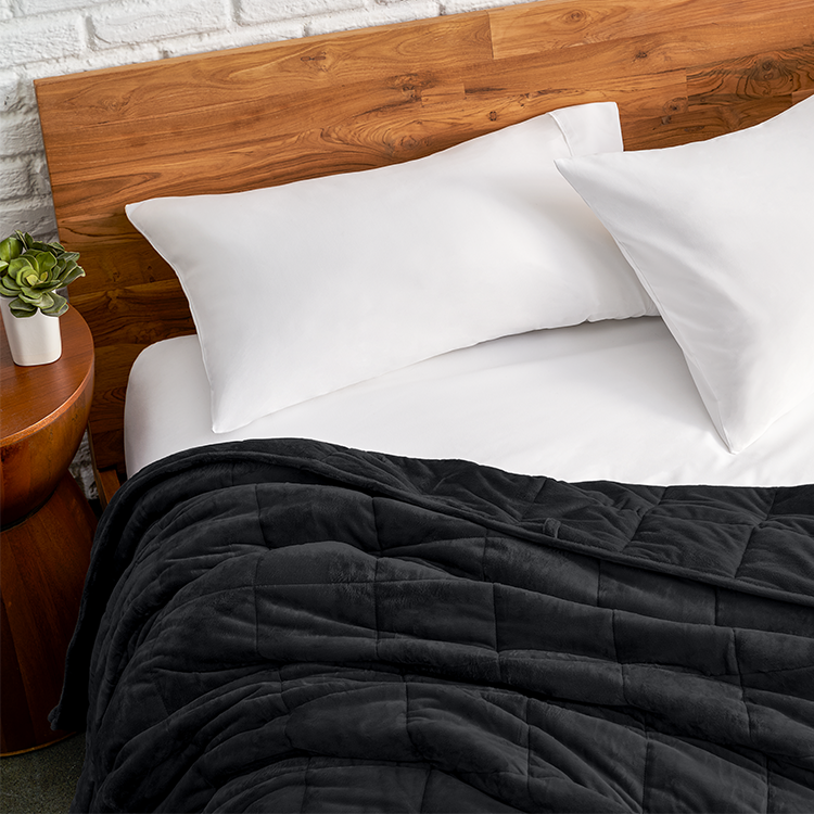 Bed with a dark gray minky fleece weighted blanket