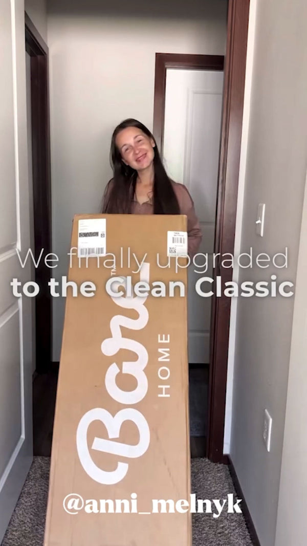 Lady holding a mattress box before opening it