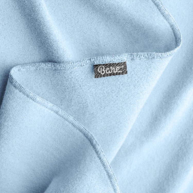 Close-up of light blue flannel fabric with a tag