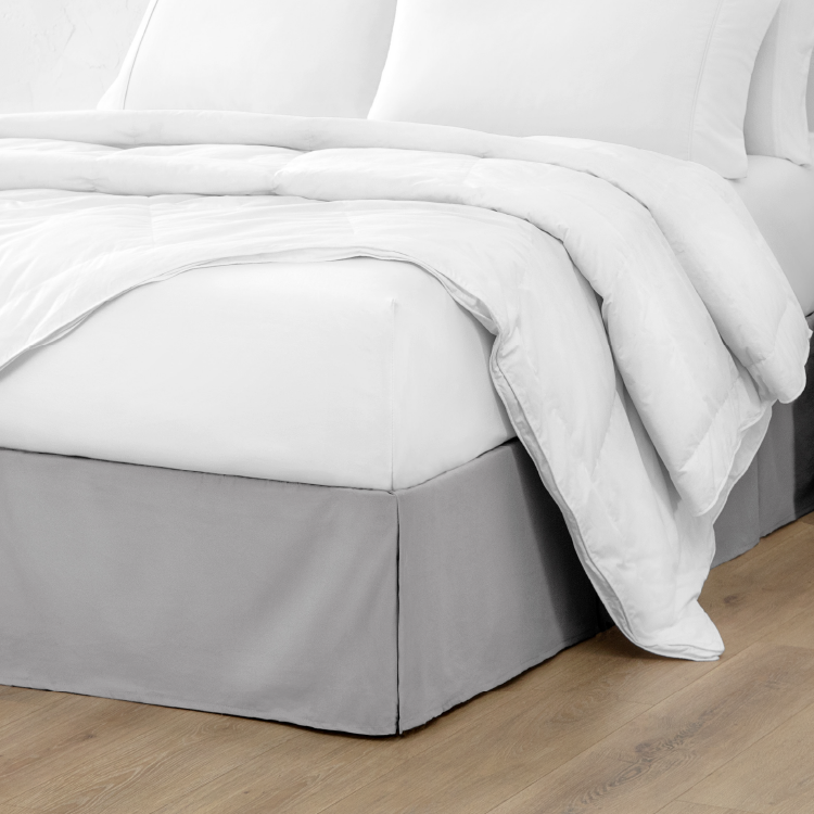 Bed with a white pleated bed skirt