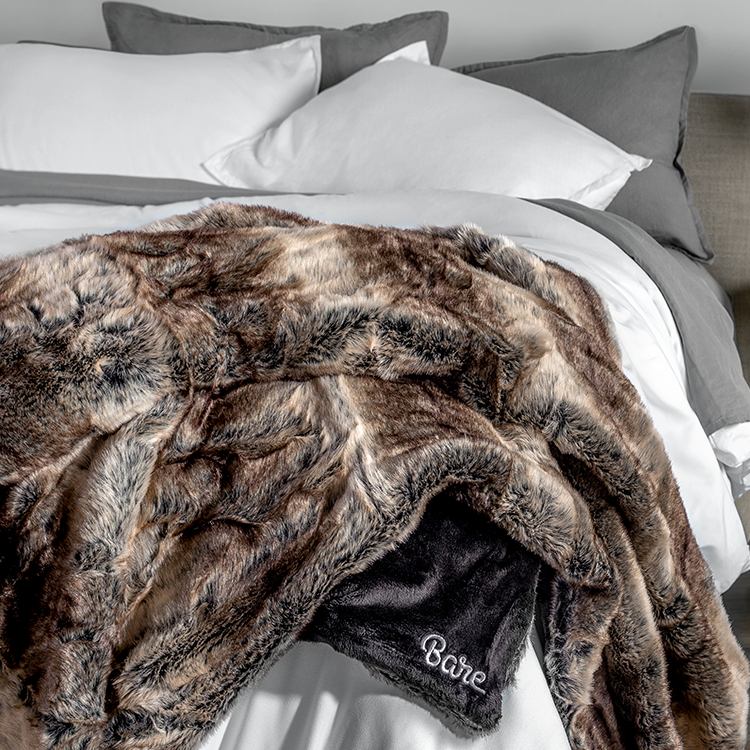 Close-up of brown and tan faux fur blanket texture