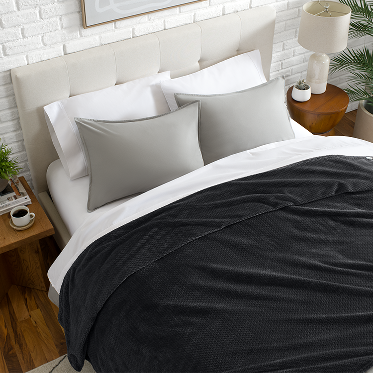 Bed with charcoal black Microplush Chevron Blanket