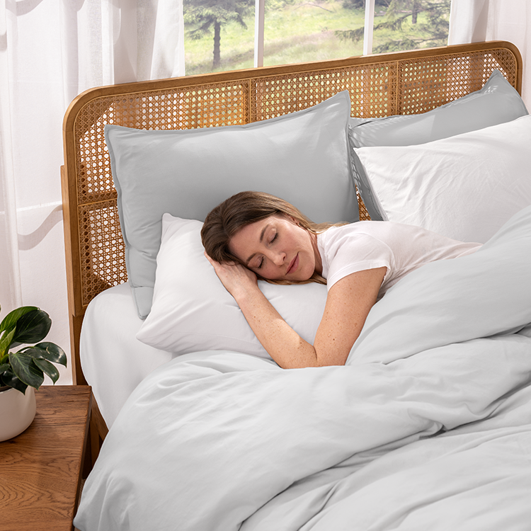 Woman sleeping in bed with Organic Cotton Jersey Bedding Bundle