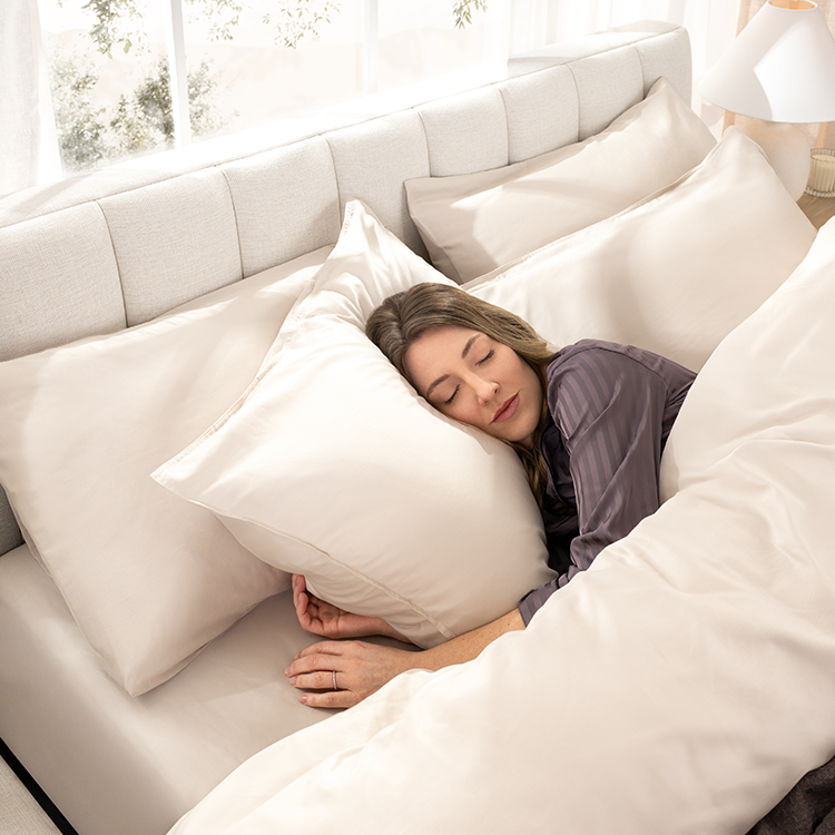 Woman resting on a pillow with white Organic Cotton Sateen Pillowcase Set