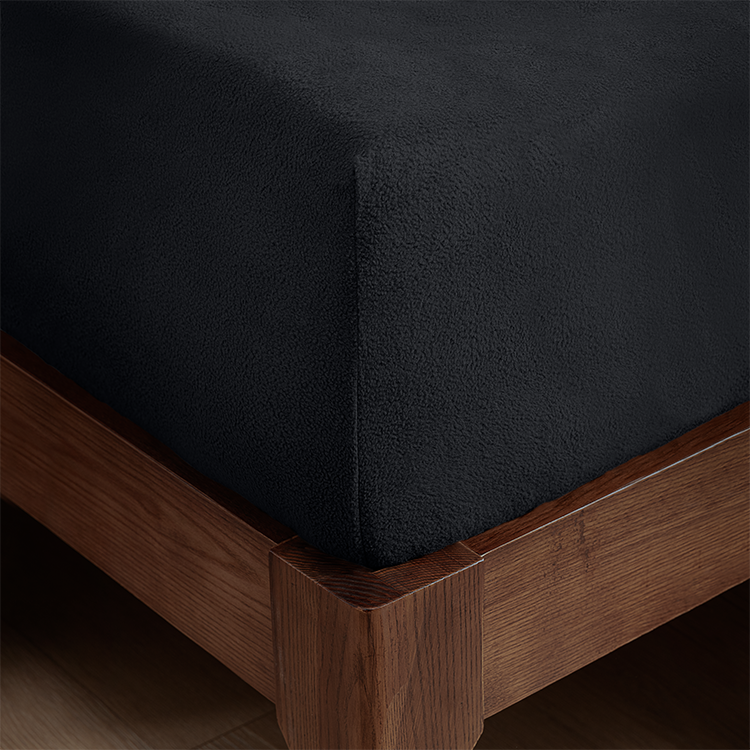 Closeup of black Polar Fleece Fitted sheet on a mattress corner