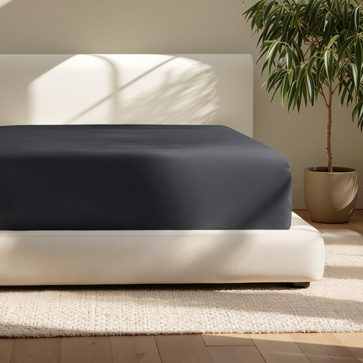 Closeup of dark navy Ultra Soft 22 Inch Pocket Fitted Sheet on a mattress corner