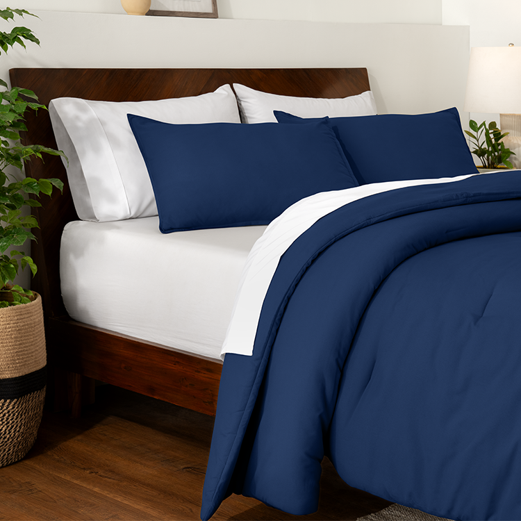 Bed styled with navy blue Ultra Soft Track Stitch Comforter Set and wood bed frame