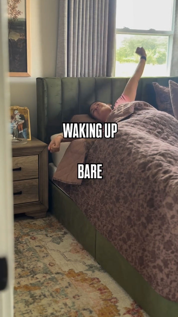 Woman waking up stretching arms on a new mattress