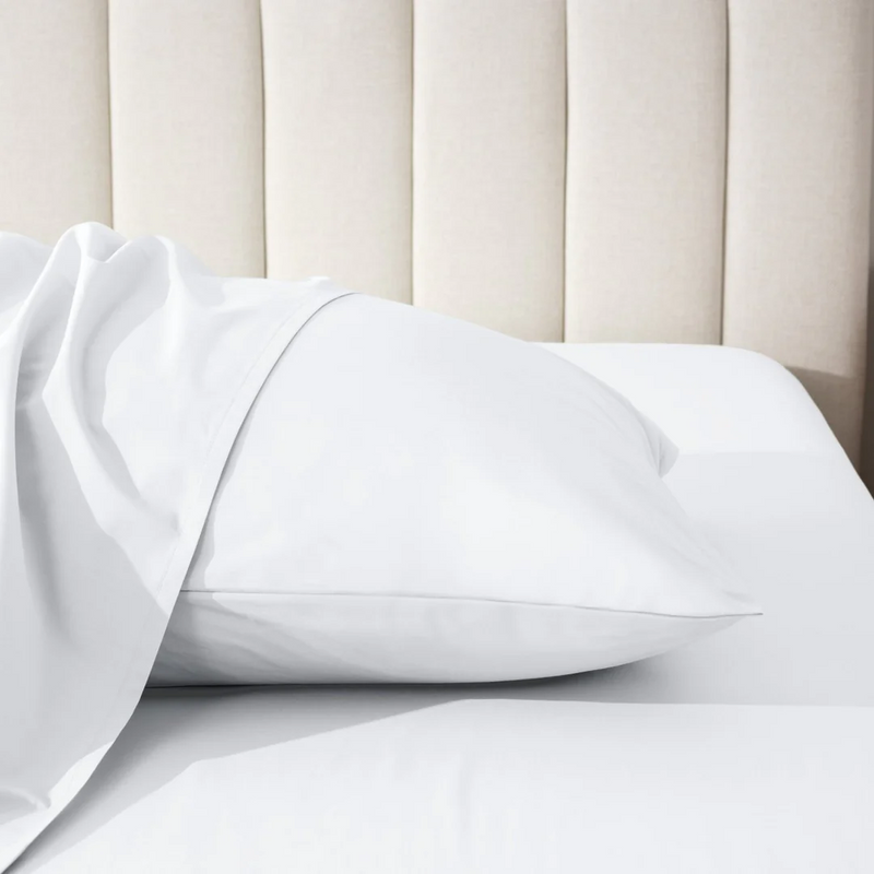 Close-up of a bed with white sheets