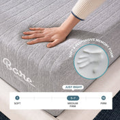 A close-up of a gray mattress with a hand pressing into it to demonstrate softness and responsiveness.