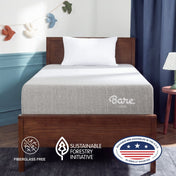 A single bed with a light gray mattress and white pillow in a styled bedroom