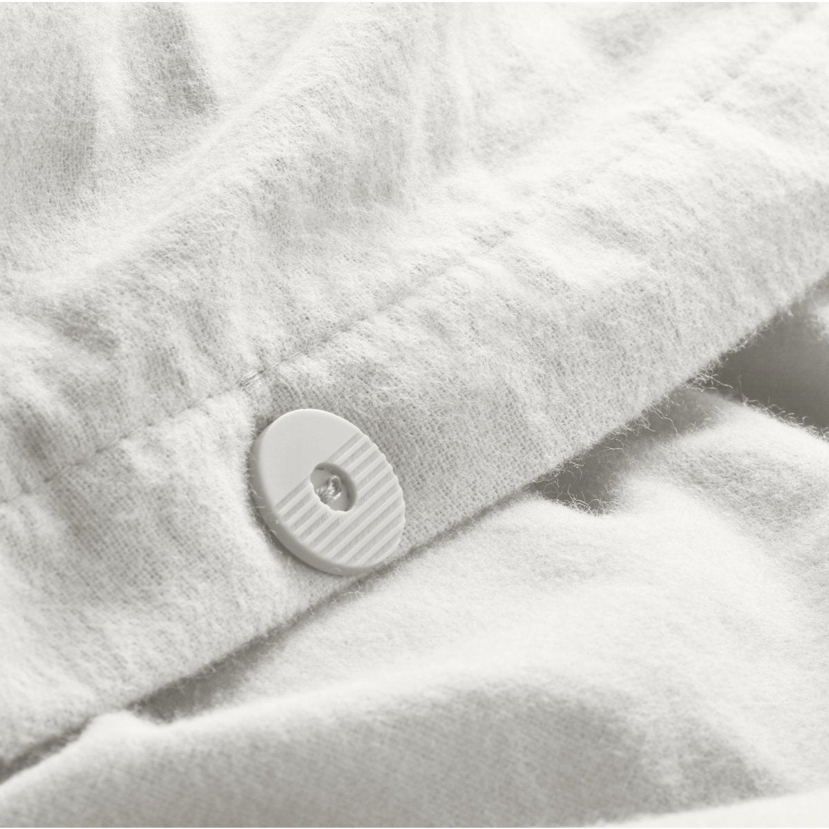 Close up of the button closure on a flannel duvet cover