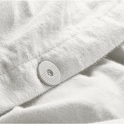 Close up of the button closure on a flannel duvet cover