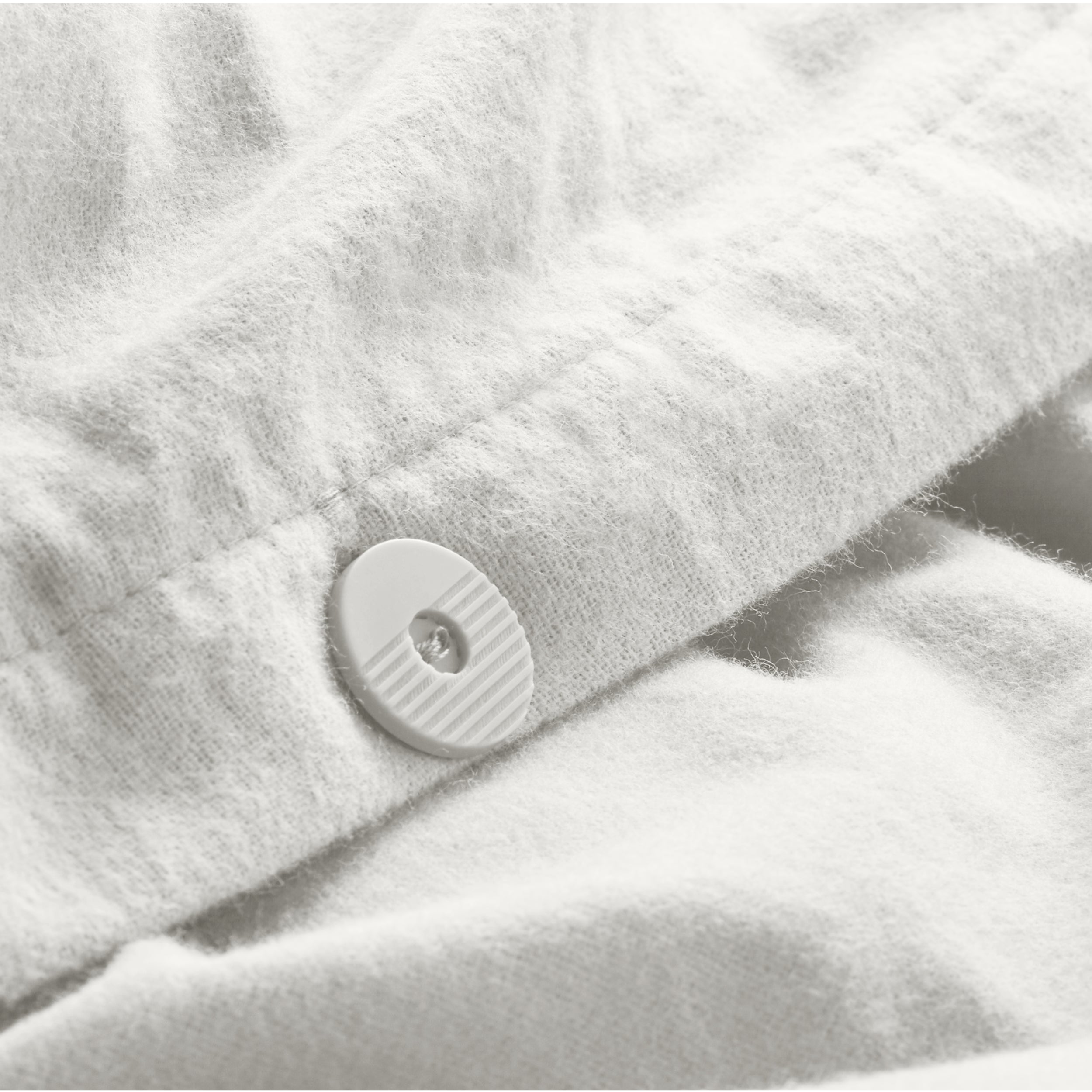 Close up of the button closure on a flannel duvet cover