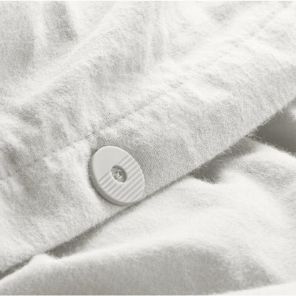 Close up of the button closure on a flannel duvet cover