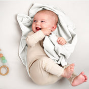 A baby lying on a flannel receiving blanket