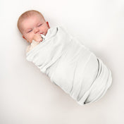 A baby wrapped in a flannel receiving blanket