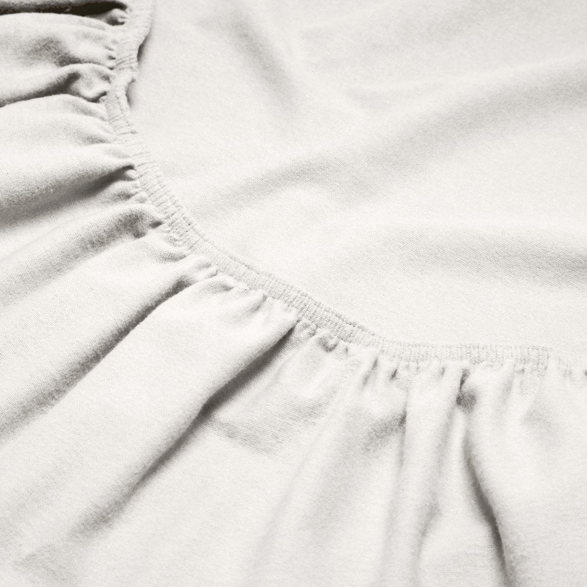 Close-up of a flannel fitted sheet with gathered elastic