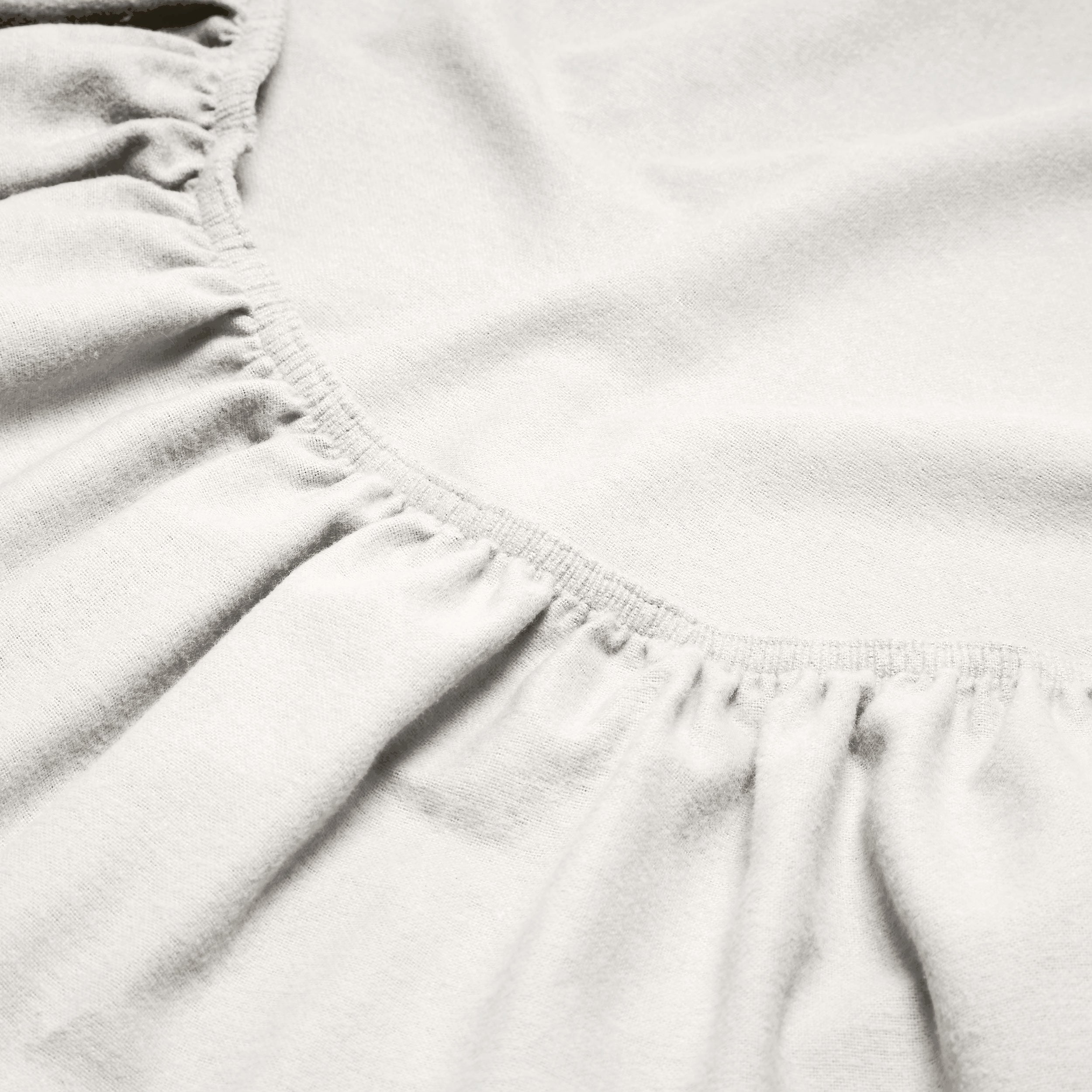 Close-up of a flannel fitted sheet with gathered elastic