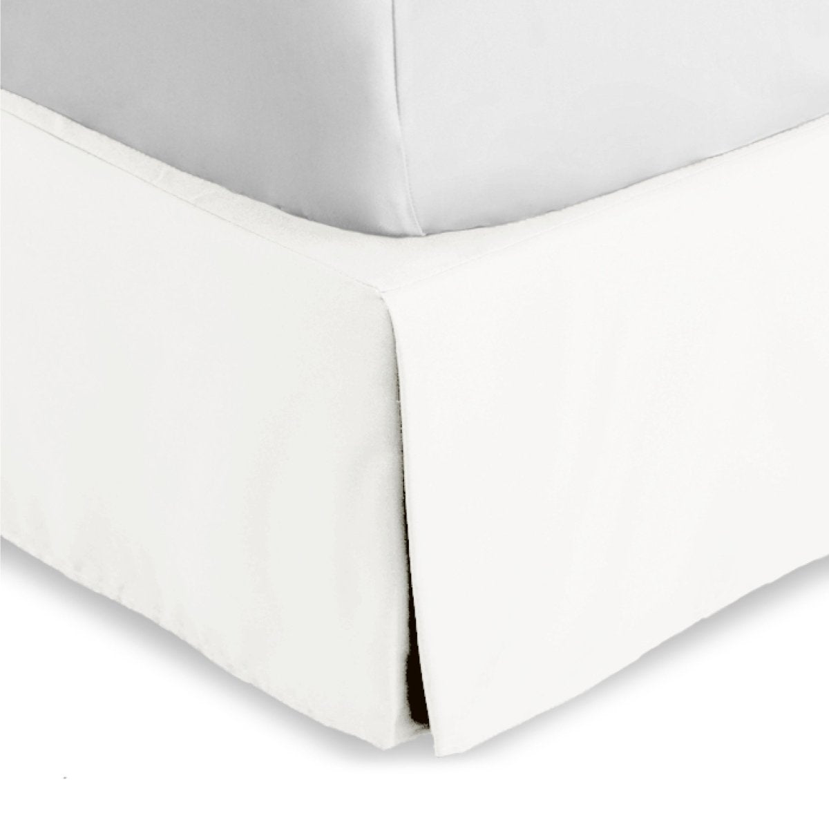 Bed skirt on a bed with white bedding