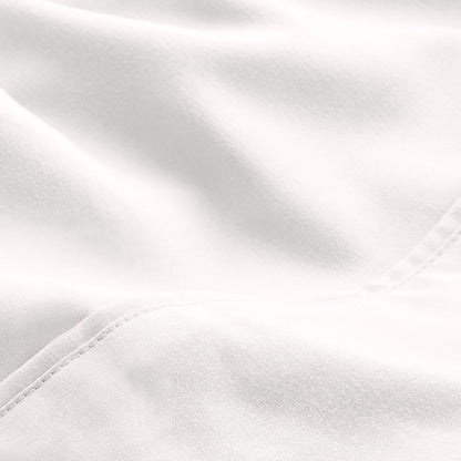 A close-up of microfiber fabric with soft folds and a visible stitched seam.