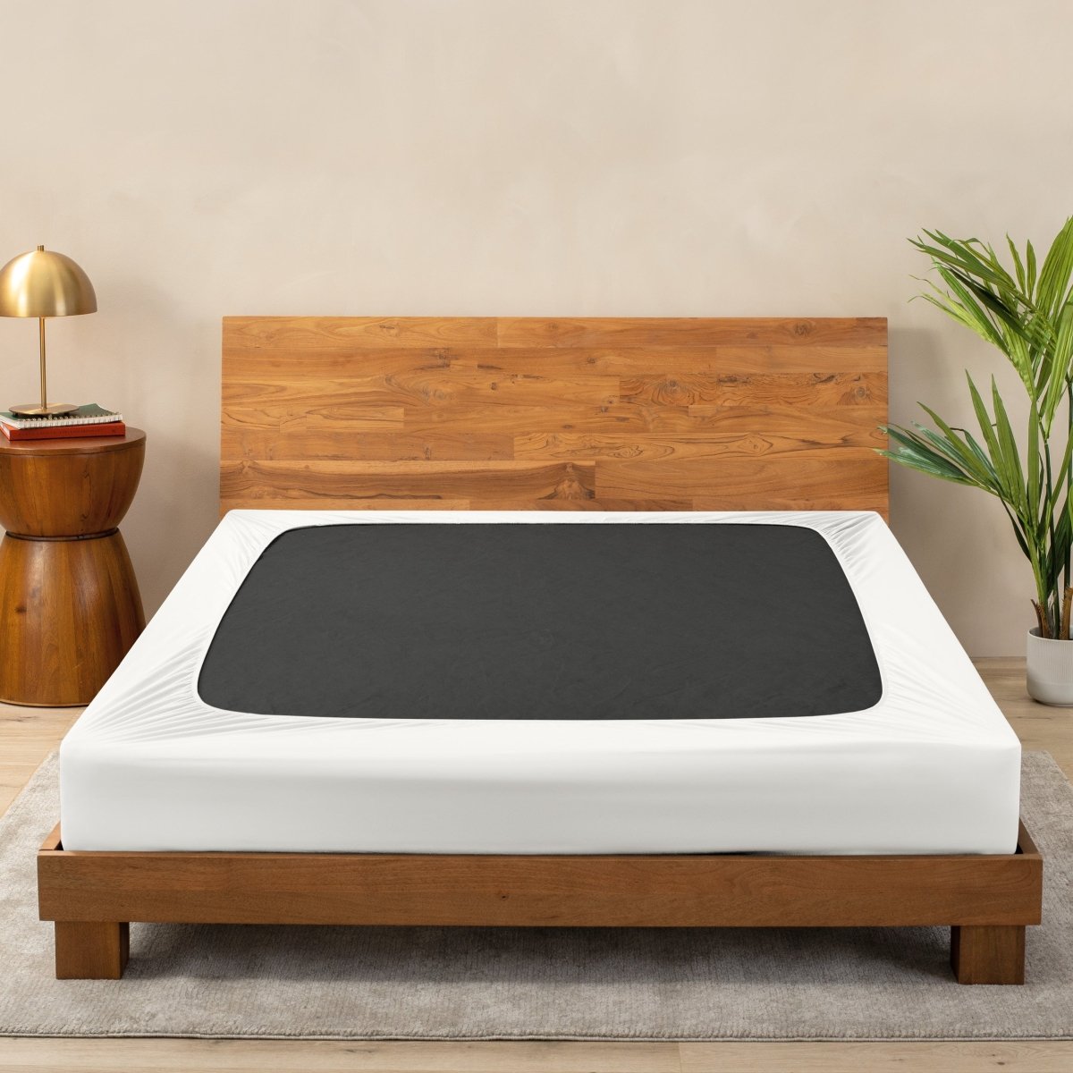 A cover on a box spring set on a wooden frame