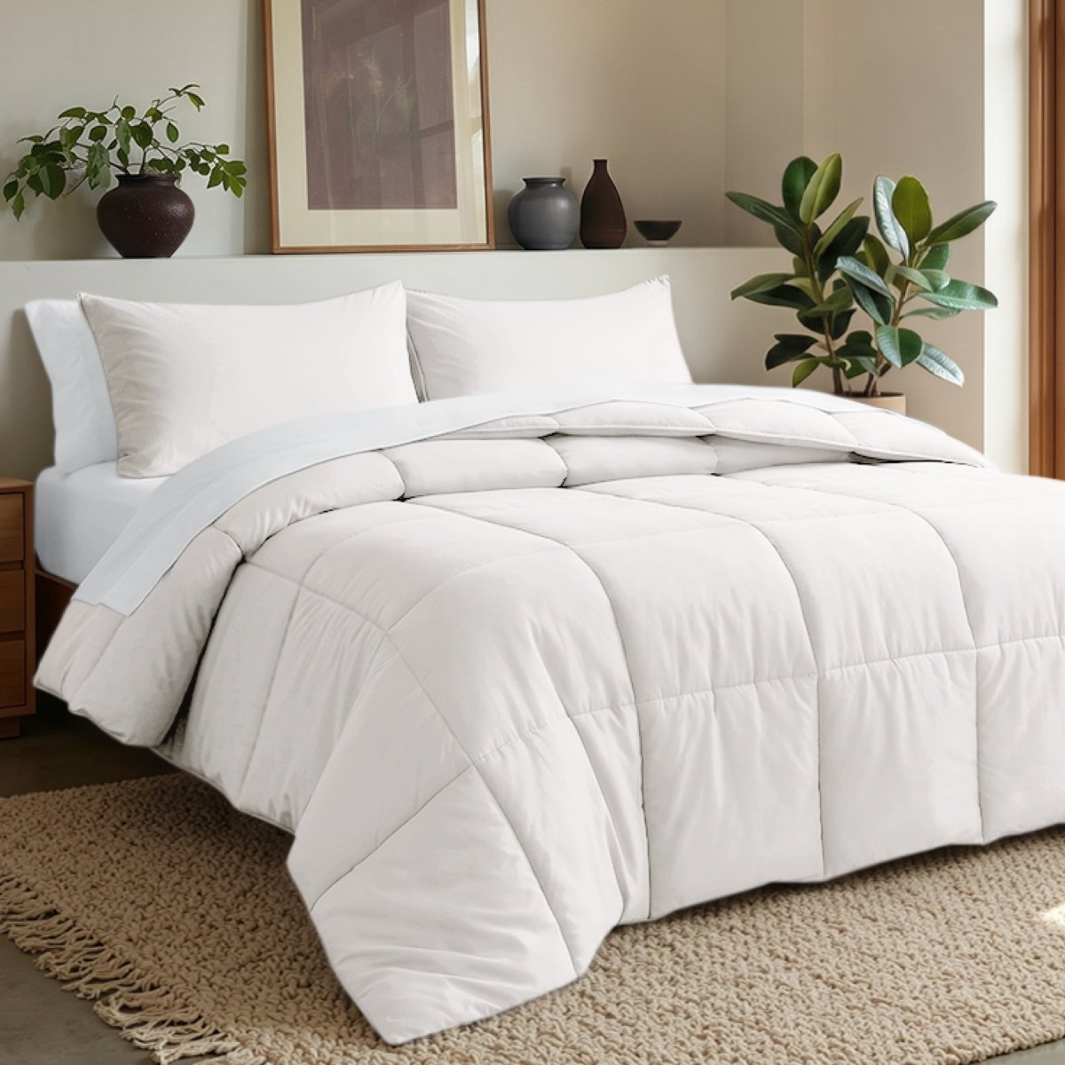 Comforter set on a bed in a bedroom with plants and decor.