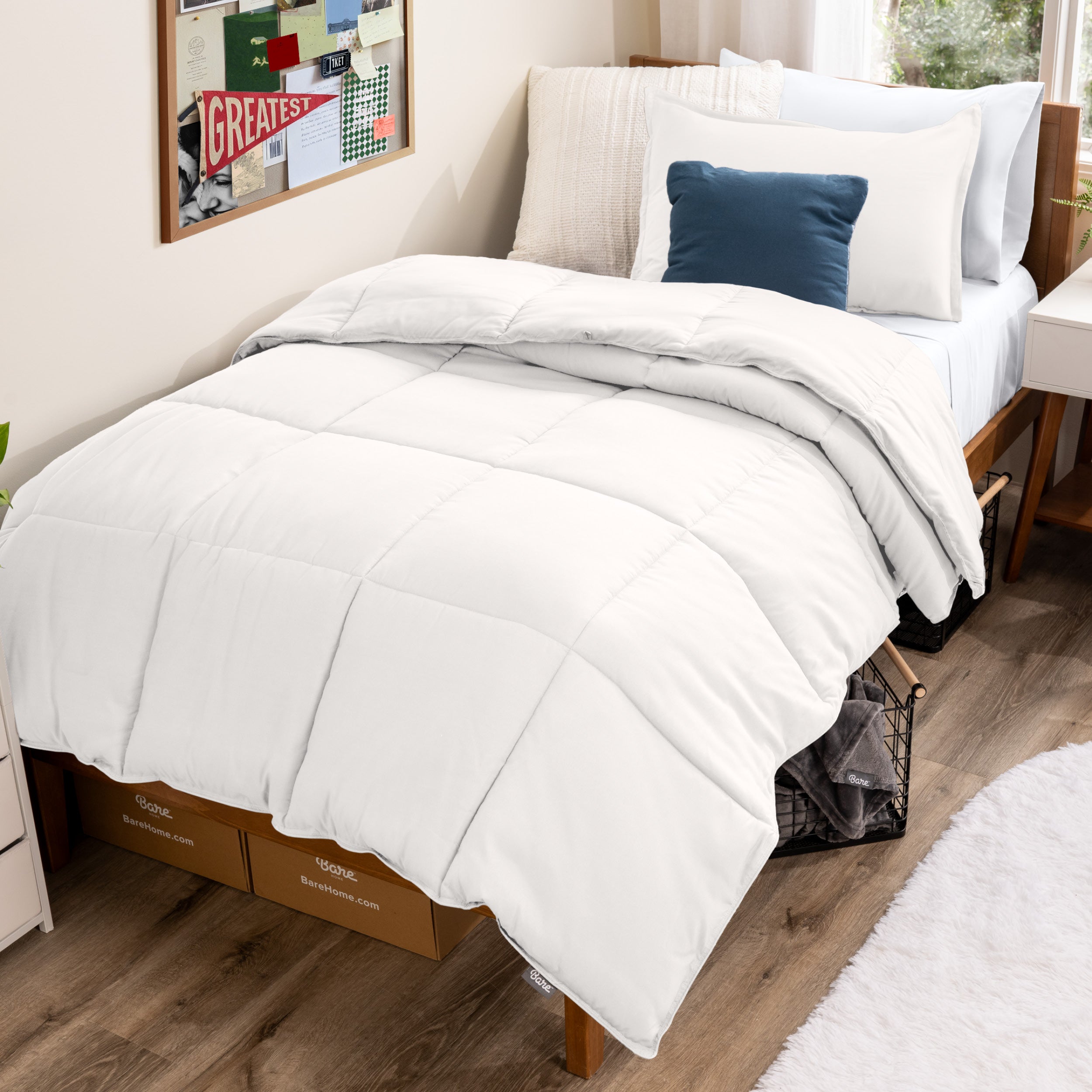Bed with comforter and pillows in a dorm room