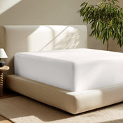 A deep pocket fitted sheet on a mattress