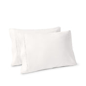 Two pillows on a white background with pillowcases on them
