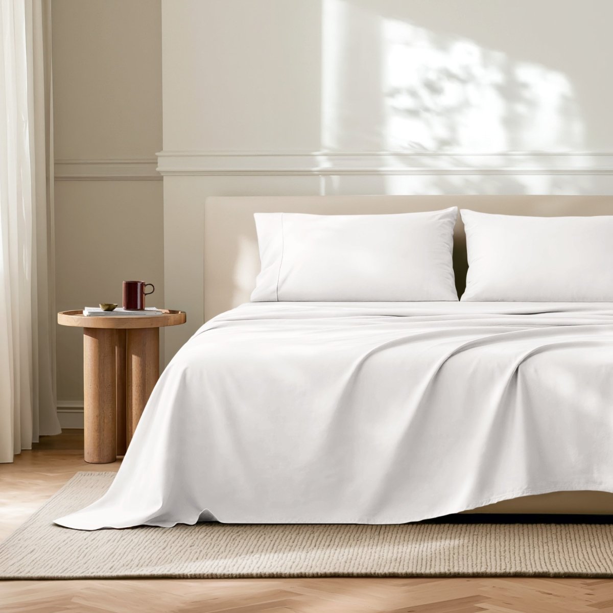 Neatly made bed with microfiber bedding in a bright bedroom.