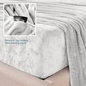 Close-up of the corner of a bed made with microplush sheets