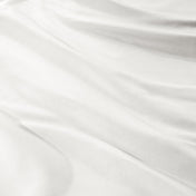 A close-up of draped sateen fabric with soft folds and a smooth texture.